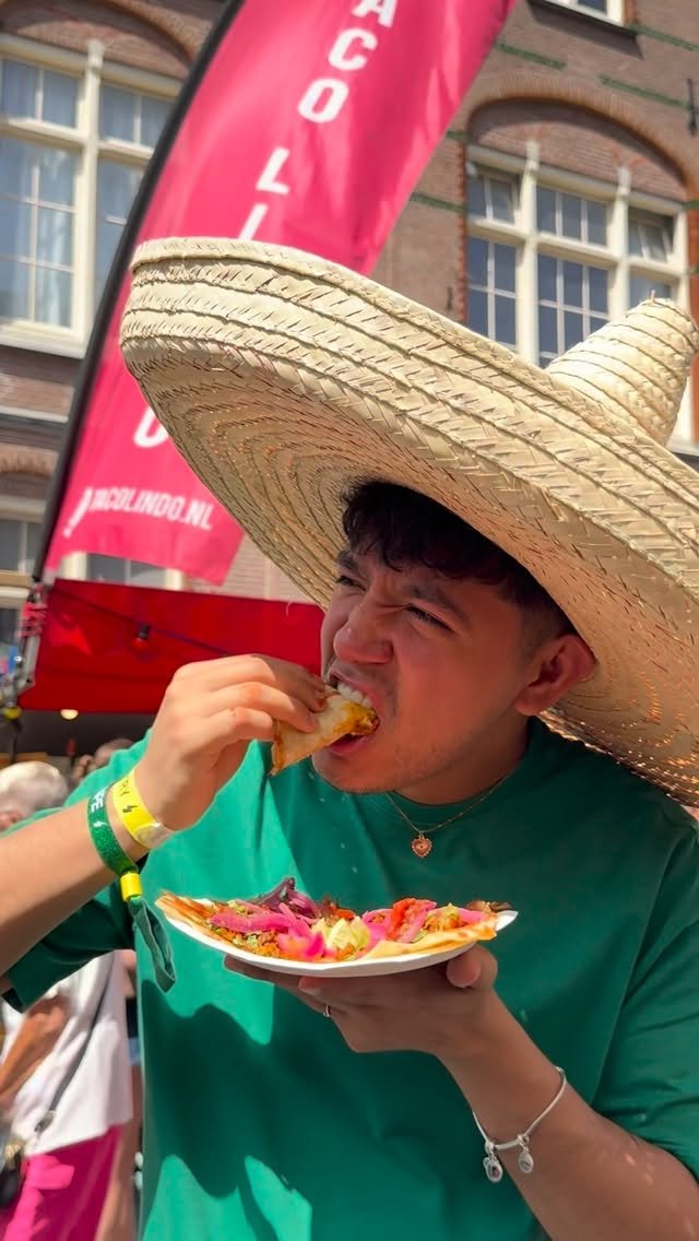 Guest eating a taco at a festival, from @tacolindo.nl on Instagram