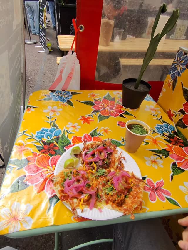 Birria tacos with consomé on the table